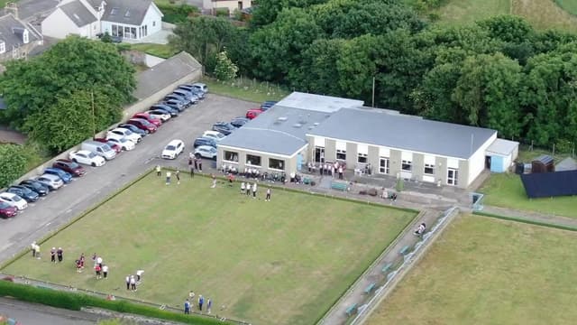 Cullen Bowling Club from above - green, clubhouse and a busy match day